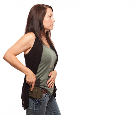 Side view of Woman Practicing Gun Safety 