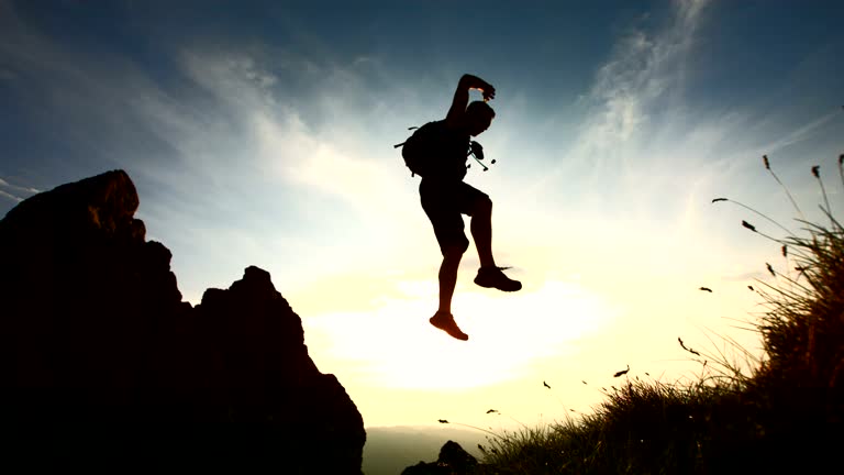 HD Super Slow-Mo: Hiker Jumping From A Rock