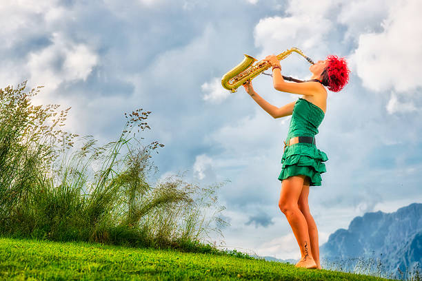 Young saxophonist (woman with the red hair) playing saxophone in