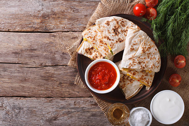 istock Quesadilla sliced and sauces on the table. horizonta top view 479312914