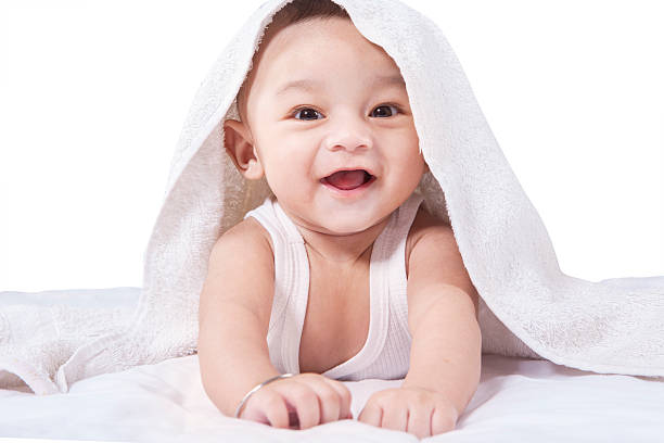 istock Sweet baby under a towel lying on bed 479313138