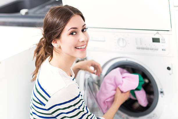 istock Woman Putting her Laundry into a Washing Machine 479313408