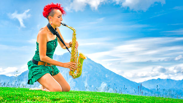 istock Young saxophonist (woman with the red hair) playing saxophone in 479324232