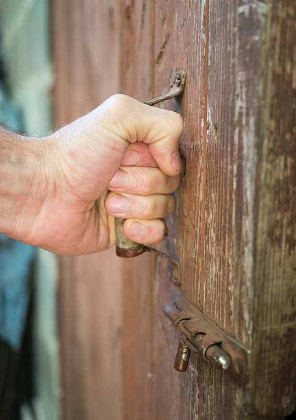 istock Hand on a handle old wooden door to open it. 479324368