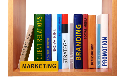 Bookshelf with marketing knowledge and skills represented in the form of books (on white background).