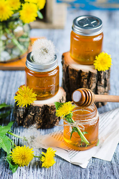 Jar with Syrup of Dandelion's flowers stock photo