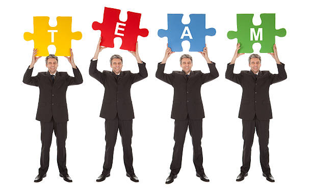 istock Group of business people holding jigsaw puzzle 479331348