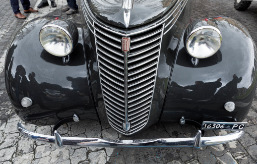 Rome, Italy - March 2, 2014: front of the hood of a Fiat 1100 BL from 1948 at the Vintage Car's Sunday Meeting in Rome, Italy, taking place close to Piramide Cestia.