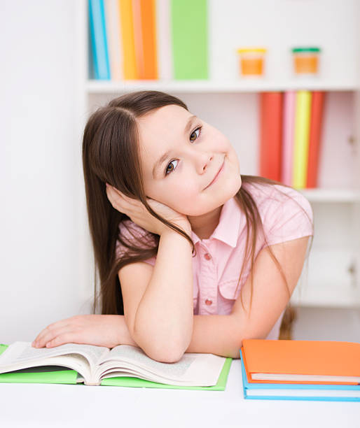 istock Little girl is reading a book 479336891