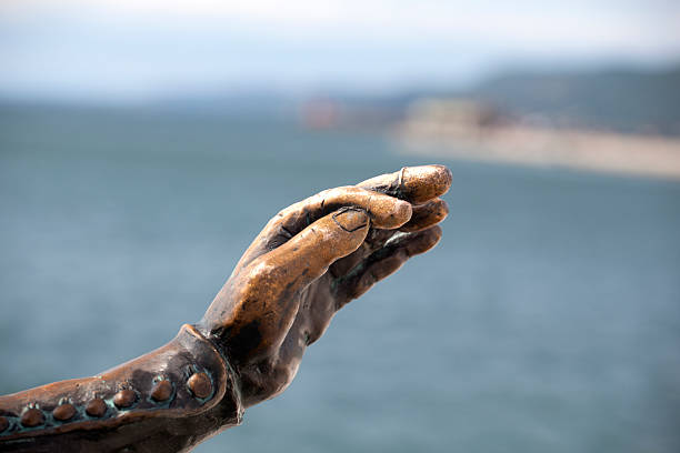 Puerto Escondido, Oaxaca Mexico, september 13 2023 sculpture of hands carved in rock related to surfing on Zicatela beach in Puerto Escondido, Oaxaca