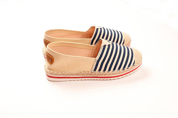istock Pair of beige espadrilles with blue and red pattern 479338850