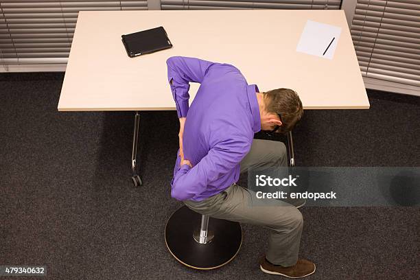 Man With Lower Back Pain In Office Work Stock Photo - Download Image Now - 2015, Activity, Adult