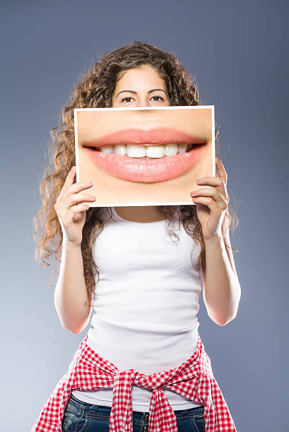istock Woman showing white blank sign billboard 479341500