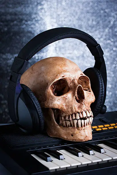 Photo of Human skull with earphones, still life