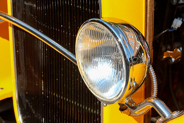 istock Chrome headlamp on a 1930's yellow sedan 479346590