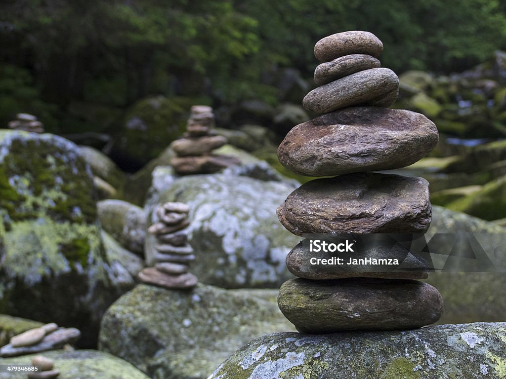 Pebbles, stacked stones as a stone statue, close up Pebbles, stacked stones as stone statues on the river Vydra, Bohemian Forest, short depth of field, forest on background, oval stones Balance Stock Photo