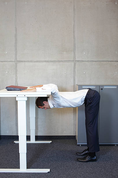 istock yoga in office. business man exercising at workplace 479346918