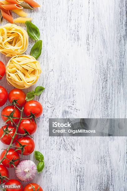 Ingredients Pasta Tomatoes Basil Frame On White Wooden Backgroun Stock Photo - Download Image Now