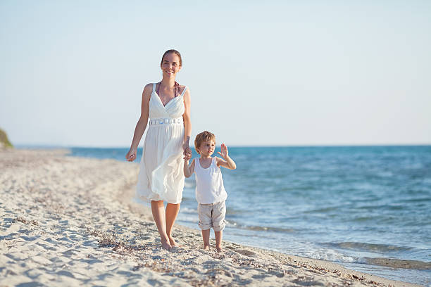istock Family Walk on the Beach 479354658
