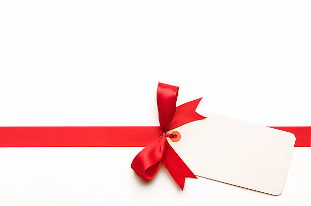 Red Bow with Blank Tag Red gift bow with blank tag tied knot photos stock pictures, royalty-free photos & images