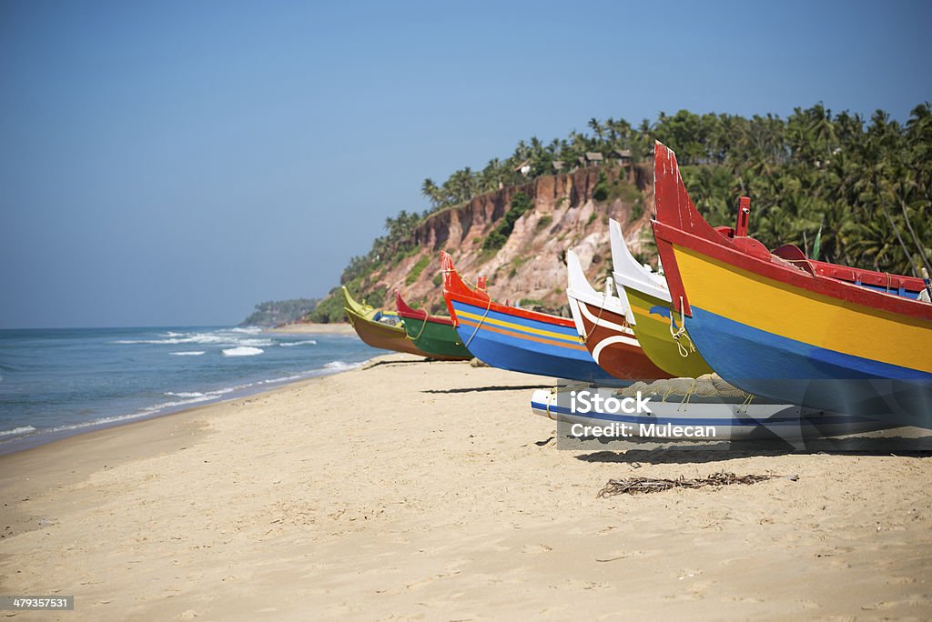 Colorful fishing boats Colorful fishing boats on beach in Varkala, Kerala, India. Kerala Stock Photo