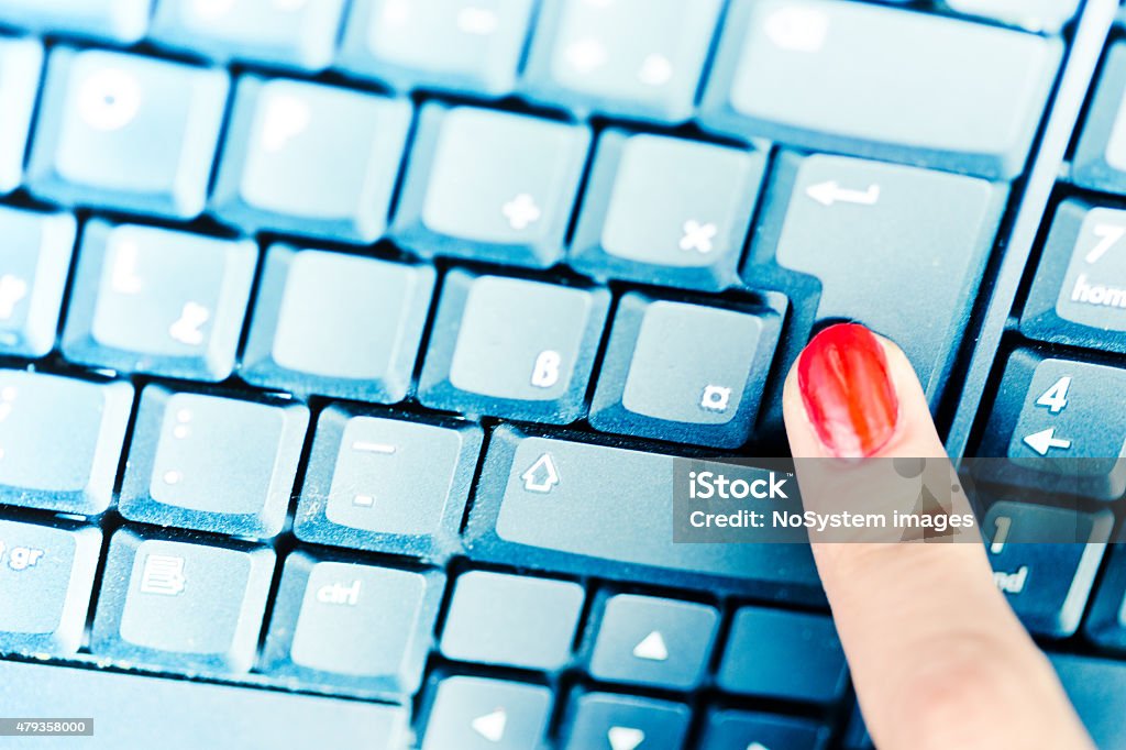 Pressing enter key Finger of a businesswoman typing on a computer keyboard,pressing enter key 2015 Stock Photo