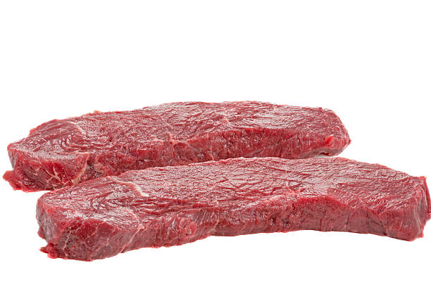 istock Two slices of raw beef on white background 479358973