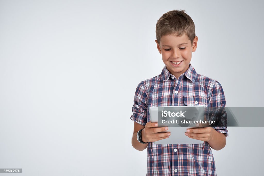 There's so much to do on a tablet Studio shot of a little boy using a digital tablet against a gray backgroundhttp://195.154.178.81/DATA/i_collage/pu/shoots/805079.jpg 2015 Stock Photo