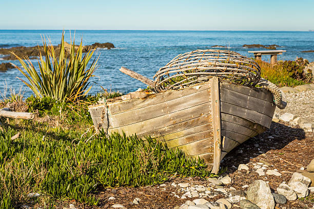 istock Old boat with a lobster trap on a seashore 479372456