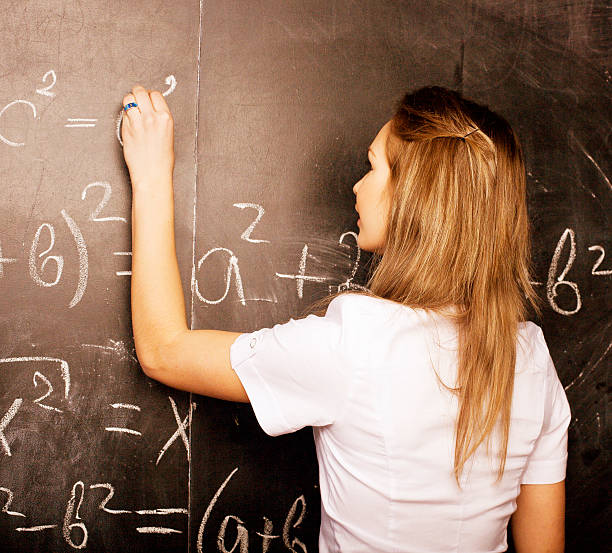 istock young pretty girl student in classroom at blackboard 479374354