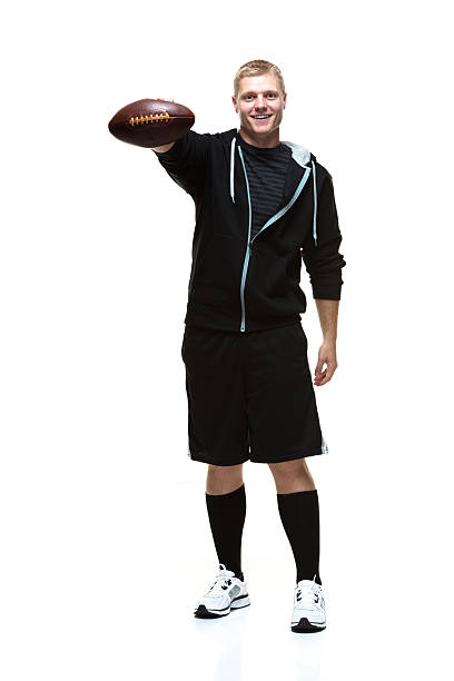 istock College student holding a football 479376031