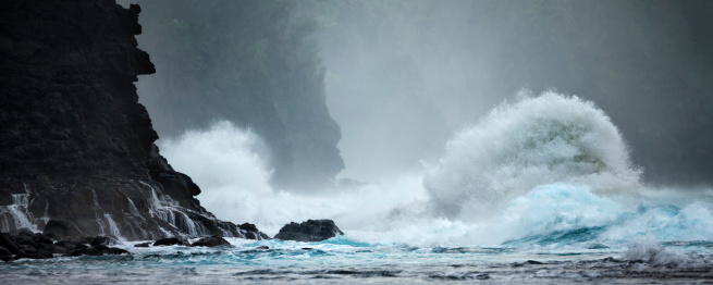 Ravenous waves of power raging against volcanic walls of resistance. Waves pound the Na Pali coast of Kauai, Hawaii.
