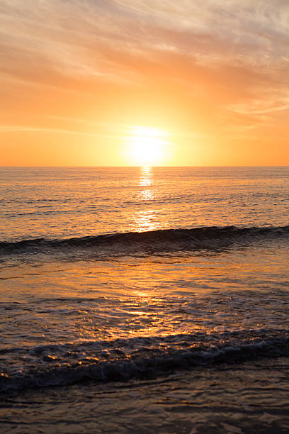 istock Sun Setting on Horizon over Ocean with Waves at Beach 479386660