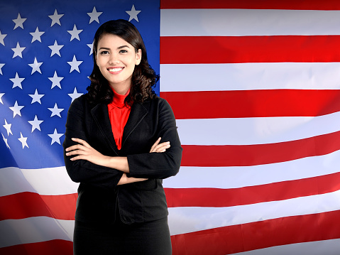 Business woman folding hand over USA flag. Working in USA concept