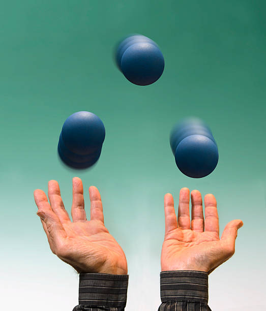 juggling three blue balls stock photo