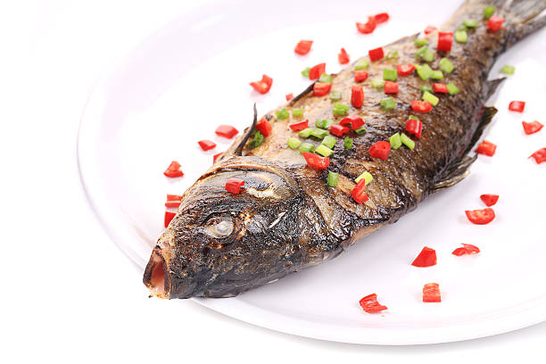 Fried fish with spring onion and red pepper.