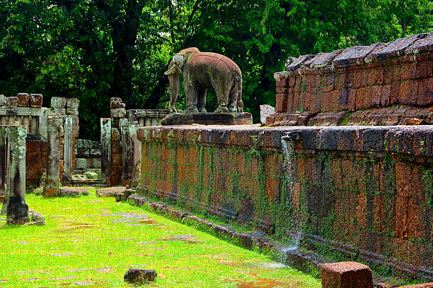 The sun powerfully comes out, after heavy rains, enlightening the sumptuous ruins of East Mebon and its massive elephant sculpture.