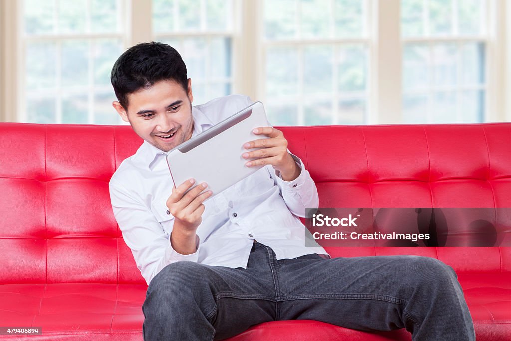 Man Playing Game Seriously With Tablet Stock Photo - Download Image Now -  2015, Adult, Asian and Indian Ethnicities - iStock