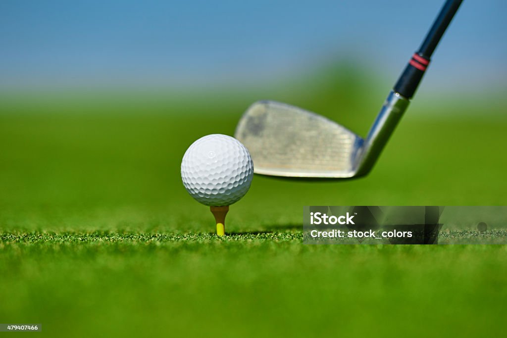 golf club hitting ball on course selective focus on golf ball near golf club, summer day, close up. 2015 Stock Photo