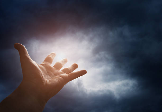 Hand reaching for the cloud in the sky