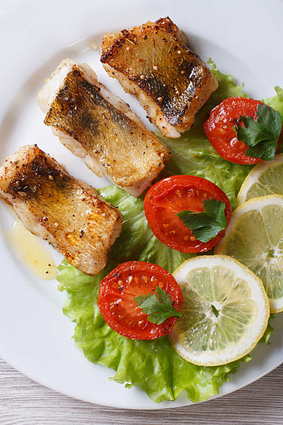 istock perch fried fillet with vegetables. vertical top view 479407952