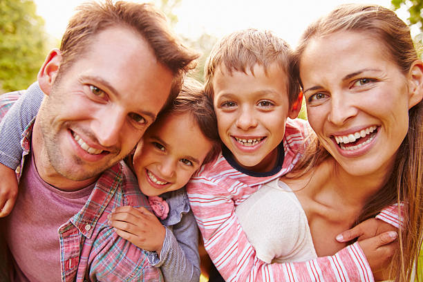 istock Young kids hugging parents outdoors, close up portrait 479408992