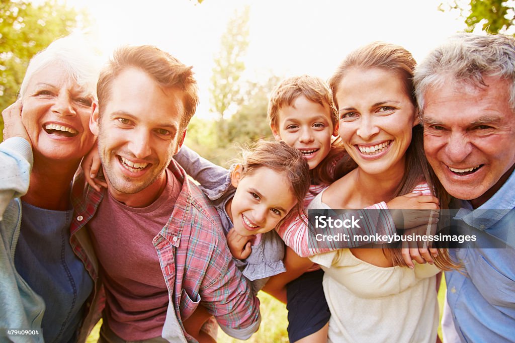 Multi-generation family having fun together outdoors Family Stock Photo