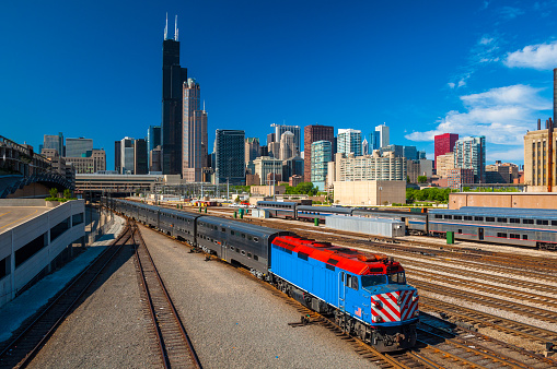 Chicago loop / downtown skyline with train tracks entering into Chicago's Union Station, with a METRA commuter train pulling out.