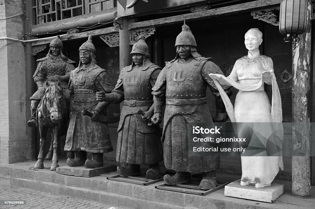 Souvenir sculptures shop in Hohhot, Inner Mongolia Hohhot, China - October 7, 2014: Sculptures of ancient mongolian warriors outside a souvenir shop, on an old street with architectural style of the Ming (1368-1644) and Qing (1644-1911) dynasties, in Hohhot, capital of north China's Inner Mongolia Autonomous Region. The street is a popular tourist venue in the city with many souvenir stores. 2015 Stock Photo