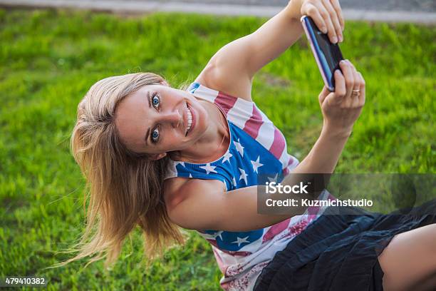 Female Model In A Tshirt With An American Flag A Stock Photo - Download Image Now - Circa 4th Century, July, Telephone