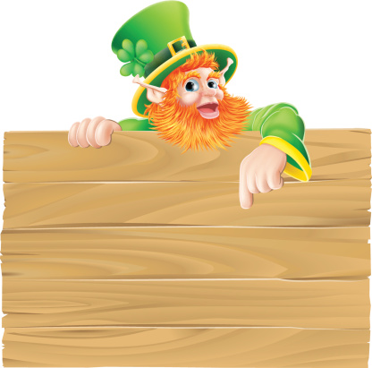 Saint Patrick s day leprachaun cartoon character pointing down at a sign