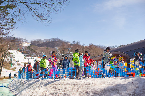 Karuizawa,Japan - 30,March,2015 : Tourists Lining up for skiing. Karuizawa is one of the few ski resorts in Japan. Conveniently located just minutes from the bullet train station and ski area, Karuizawa Prince Hotel pampers you with deluxe service and amenities in a serene, family-friendly setting.