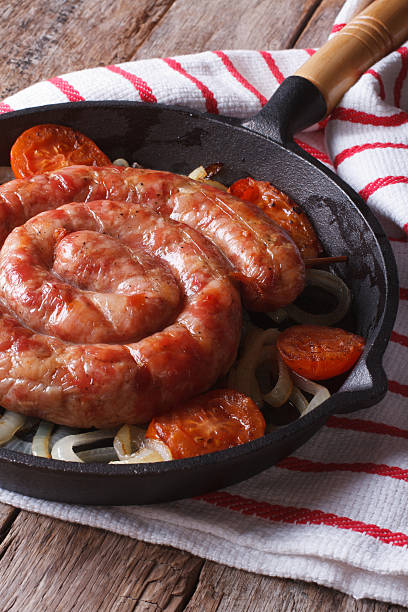 istock Grilled sausage with onions in a pan close-up. Vertical 479417344