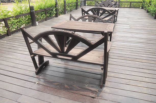 istock wooden dining table set in lush garden setting 479418014